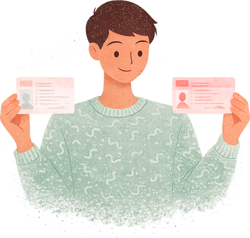 A young person with short dark brown hair in a sage green jumper, smiling and holding up a driving licence card in each hand: a paler, older one on the left and a brighter new one on the right