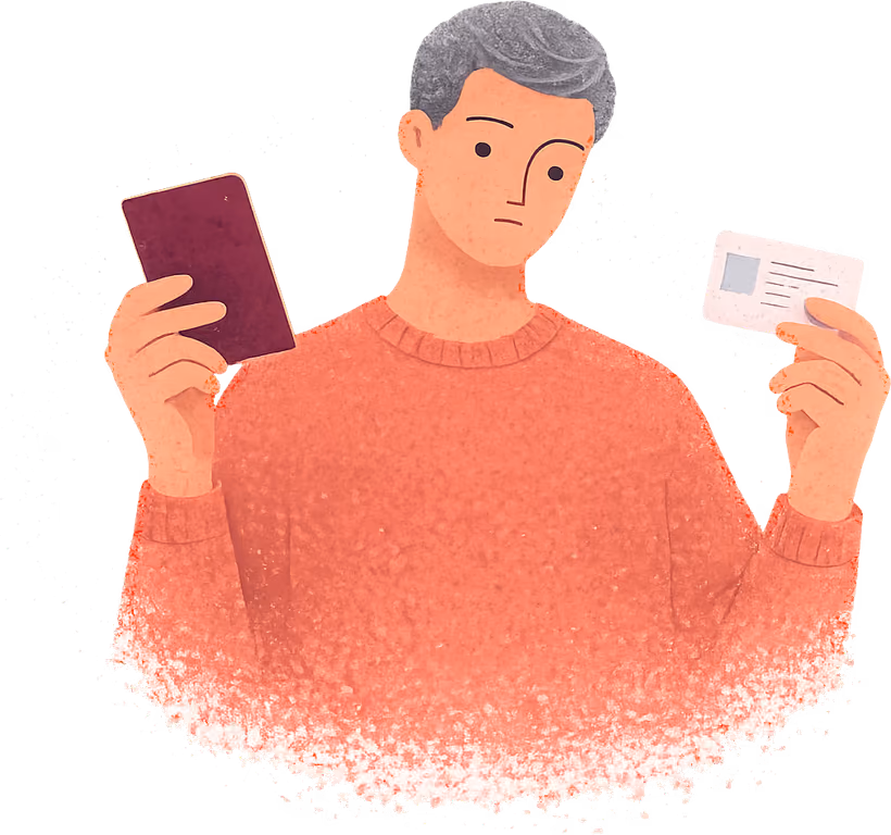 A grey-haired man in a terracotta jumper looking from a plain burgundy passport in one hand to a driving licence card in the other